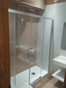 a glass shower in a bathroom with a toilet at Villajoyosa Arsenal in Villajoyosa