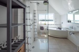 a bathroom with a tub and a sink at Fewo Ostseeflair by Seeblick Ferien in Kappeln +30 photos