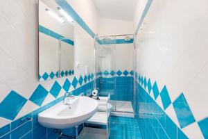 a blue and white bathroom with a sink and a mirror at Ce Tour - Casa Cetara Centro 1 in Cetara +12 photos