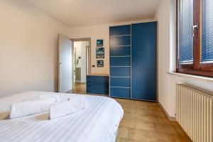 a bedroom with a large bed and a blue closet at Casa Tuly 1 in Brenzone sul Garda