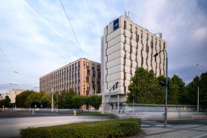 a tall white building on a city street at Clarion Congress Hotel Olomouc in Olomouc