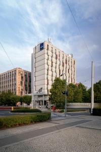a large white building on the side of a street at Clarion Congress Hotel Olomouc in Olomouc