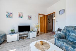 a living room with a couch and a tv at Haus Elseaue in Bünde