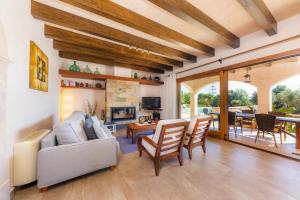 a living room with a couch and a fireplace at Finca Can Simonet in Santanyi