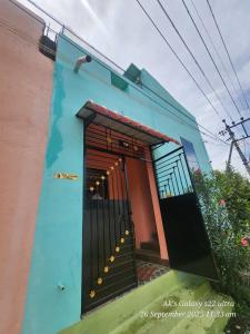 a blue building with a door and stairs on it at Le homestay villa in Puducherry