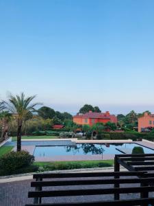 a view of a swimming pool with a bench at Casa en la playa con piscina in Miami Platja