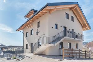 a house with a staircase on the side of it at Aster Moments Apt Max in San Genesio Atesino