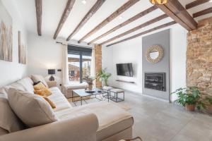 a living room with a couch and a fireplace at El Secret De Marco in Vall dʼAlba