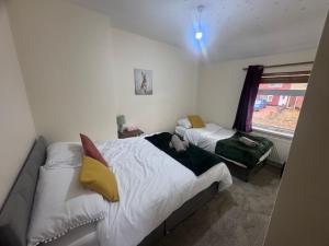 a bedroom with two beds and a window at Cosy 3 Bedroom in Birmingham in Birmingham