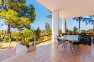 a dining room with a table and chairs on a balcony at Villa Santa Anastasia in Matino