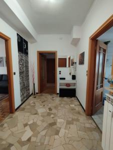 a living room with a tile floor and a kitchen at Casa Delle Gemme in Valenza +11 photos