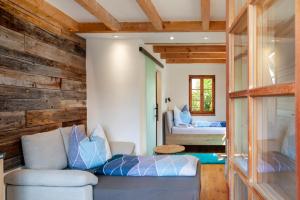 a living room with a couch and a bed at Block's Post in Krün