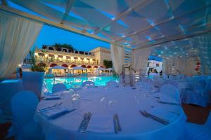 a table set up for a wedding at a pool at Messapia Hotel in Marina di Leuca