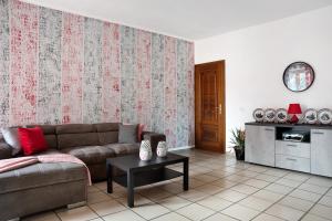 a living room with a couch and a table at Casa vacanze Nada in Dogliani