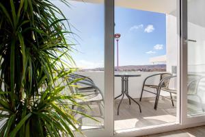a view from the balcony of a house with a table and chairs at Casa Helieta in Puerto del Rosario