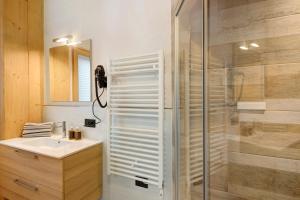 a bathroom with a sink and a glass shower at Plaz in Livigno +16 photos