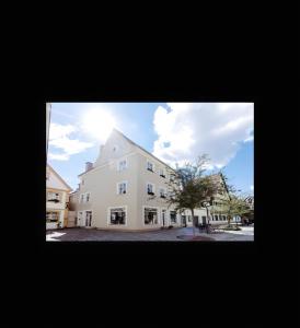 a large white building with a tree in front of it at Fewo Forchheim in Forchheim