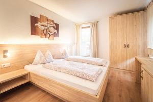 a bedroom with a large bed in a room at Apartments Silva Klausberg in San Giovanni in Val Aurina