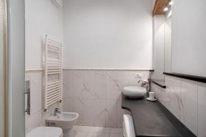 Un baño blanco con lavabo e inodoro. en Il lavatoio, borgo dei pescatori, en Cervo