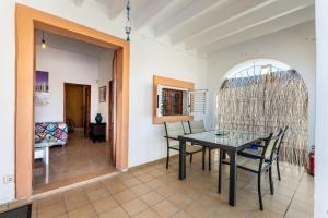 a dining room with a table and chairs at Can Pep Ramon I in Sant Jordi