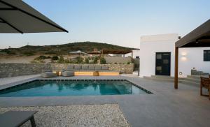 a swimming pool in the backyard of a house at ANOTERRA VILLAS -Auralis in Ambelas