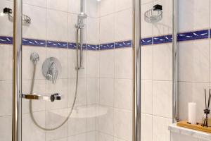 a shower with a glass door in a bathroom at Ferienwohnung Alpspitznest in Grainau +22 photos