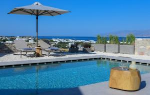 a swimming pool with an umbrella and a table with wine glasses at ANOTERRA VILLAS -Auralis in Ambelas +44 photos