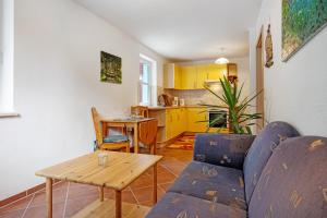 a living room with a couch and a table at Haus Seeadler Wohnung 11 in Ostseebad Koserow