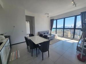 a kitchen and living room with a table and chairs at Urban Suite the Privilege Suites by Merveille in George Town