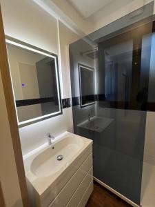 a white bathroom with a sink and a shower at Suresnes 3 cozy rooms refurbished and parking! in Suresnes