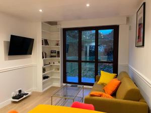 a living room with a couch and a window at Suresnes 3 cozy rooms refurbished and parking! in Suresnes