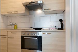 a kitchen with wooden cabinets and a stove top oven at Geyersberg mit Aussicht in Freyung