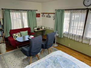 香南市にあるゲストハウス 水仙の里のテーブルと椅子のあるリビングルーム