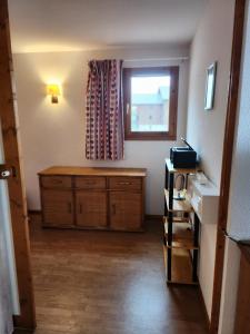 a living room with a dresser and a window at Le Parc aux étoiles 1800 in Narreyroux +18 photos