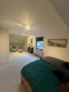 a bedroom with a bed and a living room at Zum Weserstrand in Hagen OT Rechtenfleth