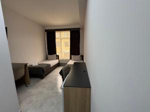 a small room with two beds and a couch at Loft Inn Ijevan in Ijevan