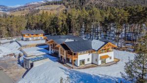 an aerial view of a house in the snow at Les Ciases Chalets Dolomites Apt 5 in San Vigilio Di Marebbe