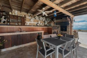 an outdoor kitchen with a table and chairs at F Tamaide in San Miguel de Abona