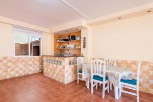 a kitchen and dining room with a table and chairs at Cozy Townhouse in Soneja in Soneja