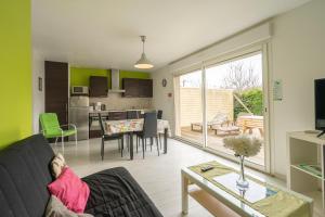 a living room with a couch and a table at La Tremblade in Saint-Simon-de-Bordes