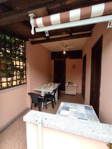 a patio with a table and chairs in a room at Villetta agli ulivi in San Teodoro +15 photos