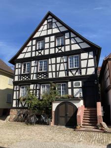 a black and white building with bikes parked in front of it at Ferienwohnung Scheffelhaus in Gengenbach