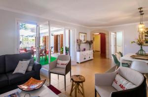 a living room with a couch and chairs and a table at Finca Es Pi in Llucmajor +16 photos