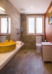a bathroom with a large tub and a toilet at Finca Es Pi in Llucmajor
