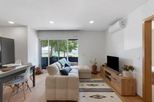 a living room with a couch and a tv at Vale viver in Vale de Cambra