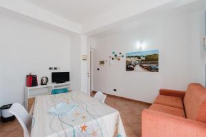 a living room with a table and a couch at Kairos San Vito Lo Capo in San Vito lo Capo