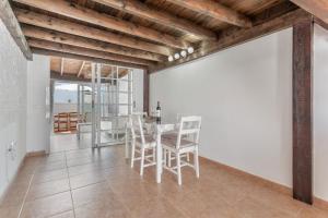 a dining room with a table and chairs at Casa vista golf in Caleta De Fuste +21 photos
