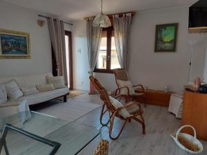a living room with a couch and chairs and a table at Casa Dea72 in Santa Luria