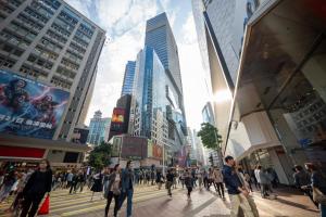 a group of people crossing a street in a city at Ha Fa Villa in Hong Kong