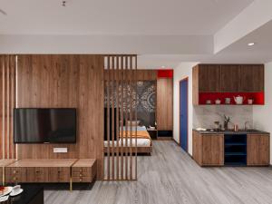 a living room with a television and a bedroom at Zone by The Park New Market Kolkata in Kolkata
